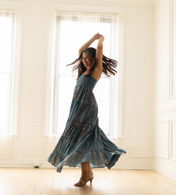 Lena dances in a teal and gold foil stamped maxi dress