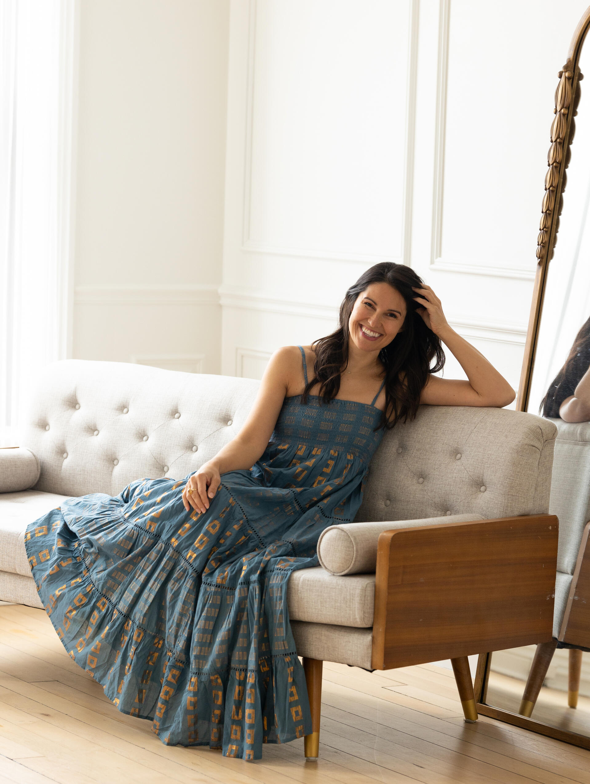 Lena dances in a teal and gold foil stamped maxi dress